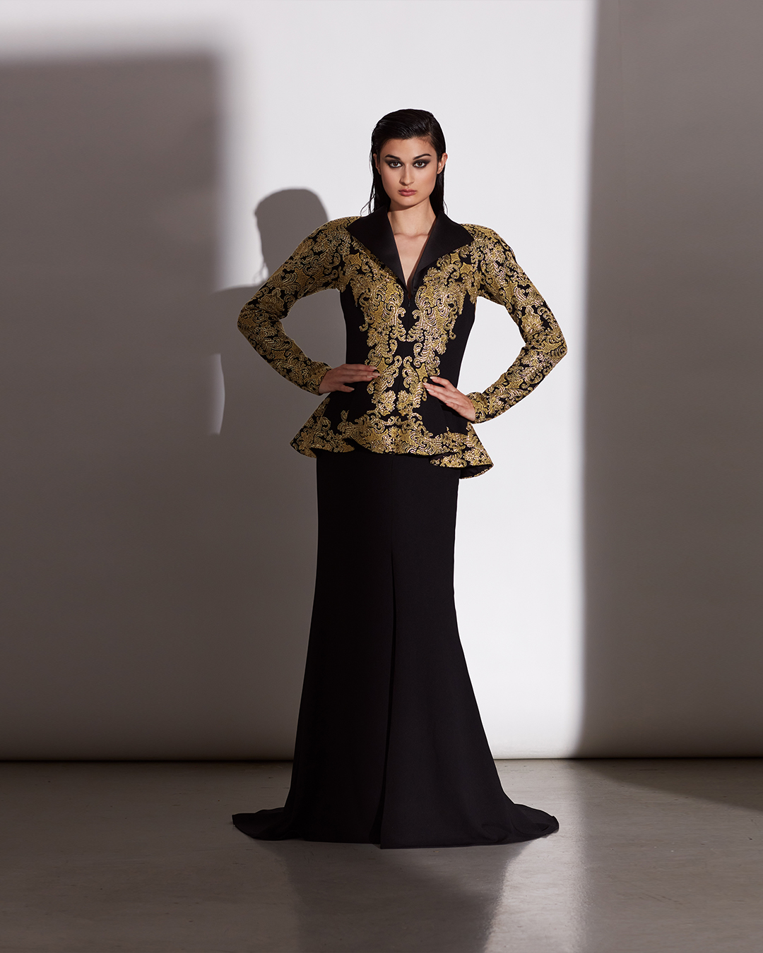 GOLD/BLACK CORD-EMBROIDERED TULLE AND TEXTURED CREPE LONG SLEEVE PEPLUM COLLAR GOWN WITH HIGH SLIT
